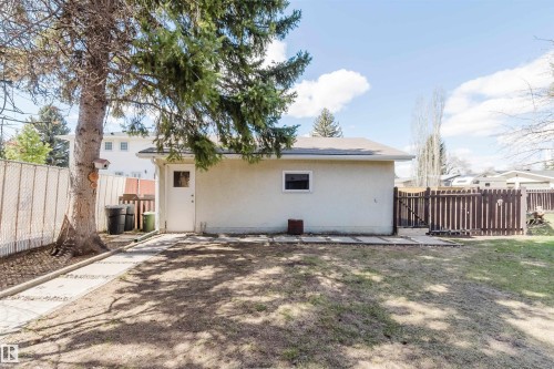 Detached garage with stucco exterior, a single entry door, and a small window - 3752 114 Street, Edmonton, AB - Outdoor