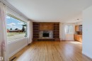 Light wood-finish flooring - 3752 114 Street, Edmonton, AB  - Indoor Photo Showing Living Room With Fireplace 