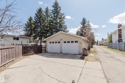 Detached two-car garage with panel-style doors and individual window inserts - 3752 114 Street, Edmonton, AB - Outdoor