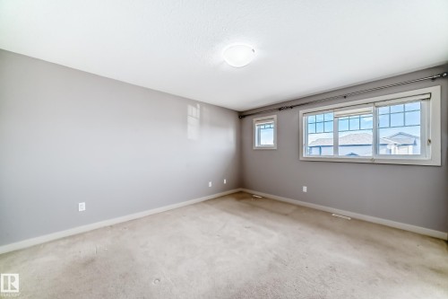 Neutral gray wall finishes complement light-colored carpeting throughout this room - 1669 Hammond Crescent Nw, Edmonton, AB - Indoor Photo Showing Other Room