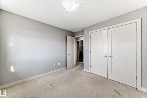 Neutral wall paint with light-colored carpeting - 1669 Hammond Crescent Nw, Edmonton, AB - Indoor Photo Showing Other Room
