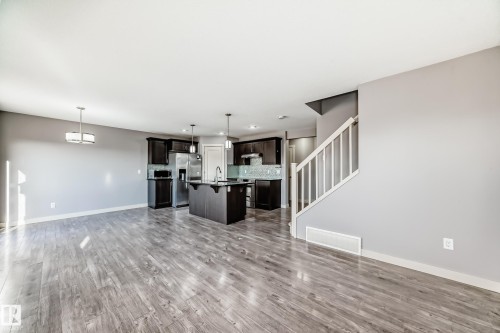 Expansive open-concept living area featuring wood-finish flooring - 1669 Hammond Crescent Nw, Edmonton, AB - Indoor