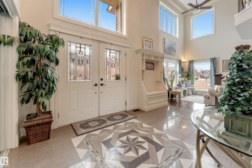 The property features a grand entryway with double doors, high ceilings, and an intricate tiled floor design - 6002 46 Avenue, Beaumont, AB - Indoor Photo Showing Other Room