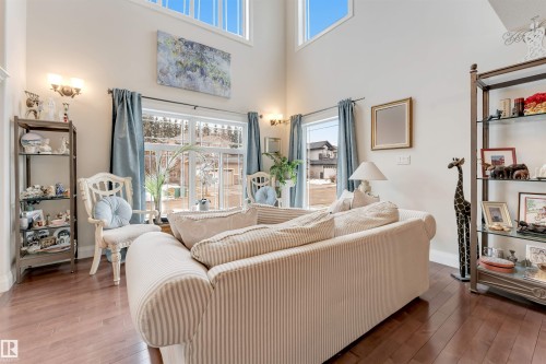 Spacious living area featuring high ceilings, large windows, and hardwood floors - 6002 46 Avenue, Beaumont, AB - Indoor Photo Showing Living Room