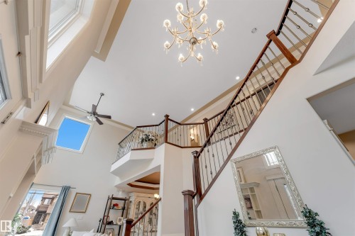 This room features a high ceiling with a chandelier, a skylight, and a ceiling fan - 6002 46 Avenue, Beaumont, AB - Indoor Photo Showing Other Room