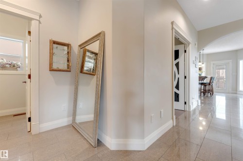The property features a bright hallway with light-colored walls and tiled flooring - 6002 46 Avenue, Beaumont, AB - Indoor Photo Showing Other Room