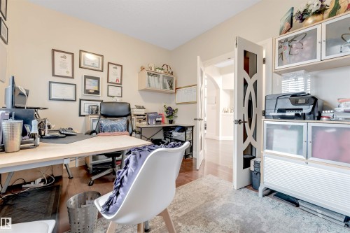 This room features rich hardwood flooring and decorative double doors - 6002 46 Avenue, Beaumont, AB - Indoor Photo Showing Office