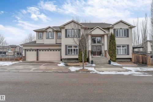 The property features a two-story design with light-colored siding and dark trim - 6002 46 Avenue, Beaumont, AB - Outdoor With Facade
