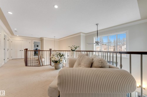 Open loft area featuring carpeted flooring, a ceiling fan, recessed lighting, and a window providing natural light - 6002 46 Avenue, Beaumont, AB - Indoor Photo Showing Other Room