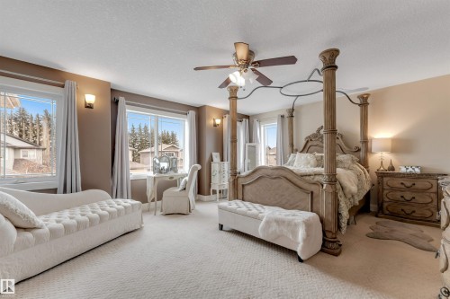 This spacious room features neutral-toned walls and plush carpeting, creating a serene ambiance - 6002 46 Avenue, Beaumont, AB - Indoor Photo Showing Bedroom