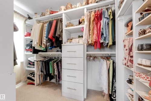 Custom closet with extensive shelving, hanging rods, and built-in drawers, providing ample storage - 6002 46 Avenue, Beaumont, AB - Indoor With Storage