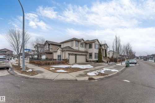 The property features a two-story exterior with an attached double garage, a fenced yard, and a paved driveway - 6002 46 Avenue, Beaumont, AB - Outdoor