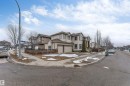 The property features a two-story exterior with an attached double garage, a fenced yard, and a paved driveway - 6002 46 Avenue, Beaumont, AB  - Outdoor 