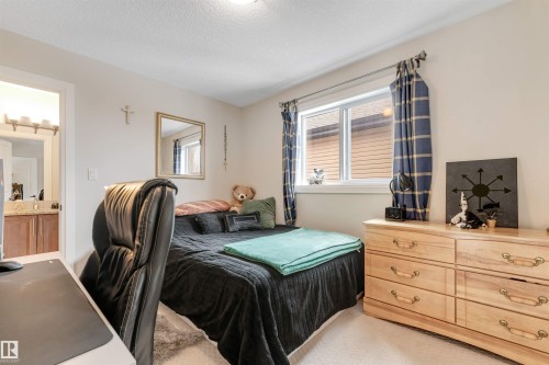 This room features light-colored walls and carpeted flooring - 6002 46 Avenue, Beaumont, AB - Indoor Photo Showing Bedroom