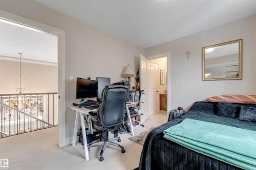 Bedroom featuring carpeted flooring and a desk area - 6002 46 Avenue, Beaumont, AB - Indoor