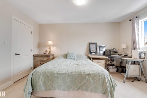 The room features a window with natural light, neutral painted walls, and carpeted flooring - 6002 46 Avenue, Beaumont, AB - Indoor Photo Showing Bedroom