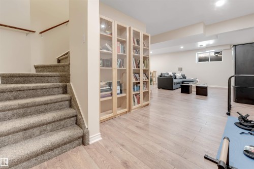 This expansive lower level features light wood flooring, recessed lighting, and a large window providing natural illumination - 6002 46 Avenue, Beaumont, AB - Indoor