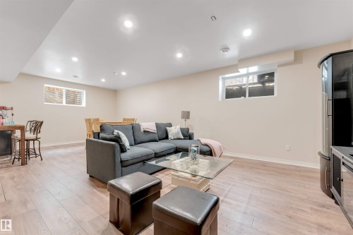 Spacious room featuring light wood flooring, neutral colored walls, and recessed lighting - 6002 46 Avenue, Beaumont, AB - Indoor Photo Showing Basement
