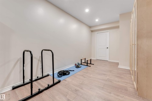 The room features light-toned flooring and recessed lighting - 6002 46 Avenue, Beaumont, AB - Indoor Photo Showing Other Room