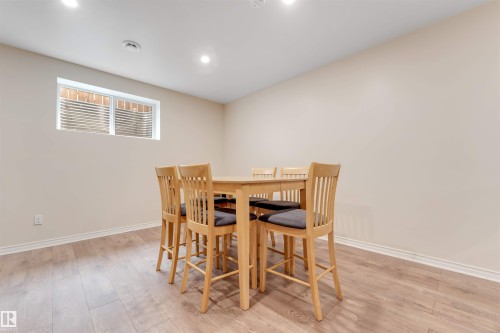 Spacious room featuring light-toned walls, recessed lighting, and durable wood-look flooring - 6002 46 Avenue, Beaumont, AB - Indoor