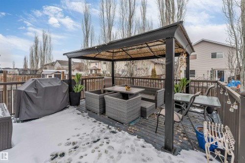 The property features an outdoor deck with a dark-framed gazebo and outdoor seating - 6002 46 Avenue, Beaumont, AB - Outdoor With Deck Patio Veranda With Exterior