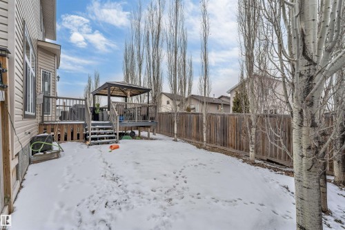 The property features an extensive backyard with a wooden deck and a gazebo, surrounded by a wooden fence - 6002 46 Avenue, Beaumont, AB - Outdoor
