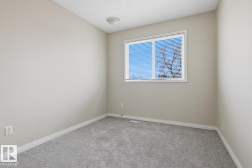 Light gray wall paint complemented by white trim and a neutral carpet - 10640 Beaumaris Road, Edmonton, AB - Indoor Photo Showing Other Room