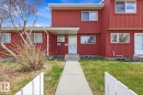 Red vertical siding exterior with white trim windows and a concrete walkway - 10640 Beaumaris Road, Edmonton, AB  - Outdoor 
