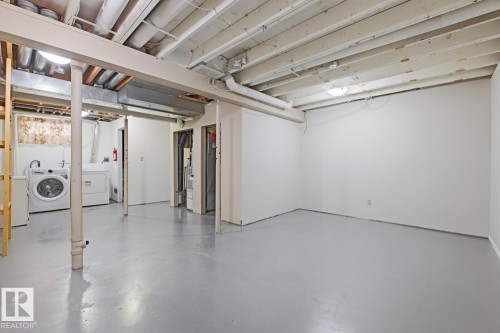 Spacious unfinished basement featuring white walls and a light gray finished concrete floor - 10640 Beaumaris Road, Edmonton, AB - Indoor Photo Showing Other Room