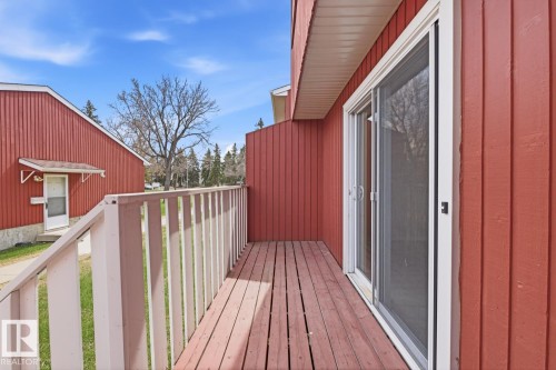 Private outdoor balcony featuring wood-finish flooring and a white railing - 10640 Beaumaris Road, Edmonton, AB - Outdoor With Deck Patio Veranda With Exterior
