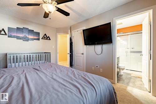 Bedroom featuring a ceiling fan and direct access to a bathroom with a shower - 40 12004 22 Avenue, Edmonton, AB - Indoor Photo Showing Bedroom