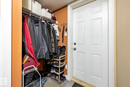 The property includes a functional entryway with a white paneled door and an integrated closet featuring wire shelving - 40 12004 22 Avenue, Edmonton, AB - Indoor With Storage