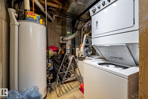 The property includes a water heater and a stacked washer and dryer unit - 40 12004 22 Avenue, Edmonton, AB - Indoor