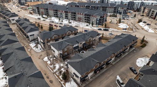 Aerial view showcasing rows of properties with dark-colored roofs and light-colored siding - 40 12004 22 Avenue, Edmonton, AB - Outdoor With View