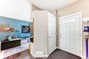 Entryway featuring a paneled front door with upper lites, wood-finish flooring, a built-in closet, and neutral wall tones - 5020 Orchards Gate, Edmonton, AB  - Indoor Photo Showing Other Room 