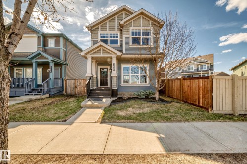 Two-story residence featuring a covered front entry with white columns and dark railing - 5020 Orchards Gate, Edmonton, AB - Outdoor With Facade