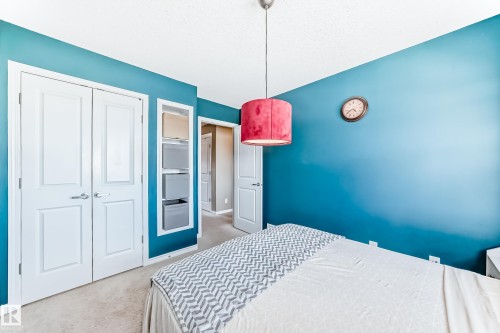 Carpeted room featuring a white ceiling and teal walls - 5020 Orchards Gate, Edmonton, AB - Indoor Photo Showing Bedroom