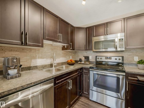 Virtually Staged - 24 4029 Orchards Drive, Edmonton, AB - Indoor Photo Showing Kitchen With Stainless Steel Kitchen With Double Sink