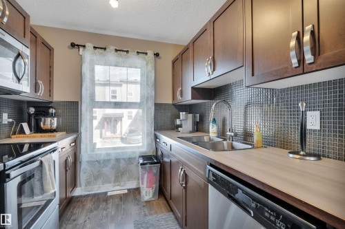 309 401 Southfork Drive, Leduc, AB - Indoor Photo Showing Kitchen With Stainless Steel Kitchen With Double Sink With Upgraded Kitchen