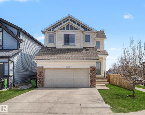 Two-story home with light siding and dark shingle roof - 9483 227 Street, Edmonton, AB - Outdoor