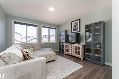 Bright living space featuring wood-finish flooring and light-toned walls - 1450 Darby Green, Edmonton, AB - Indoor Photo Showing Living Room