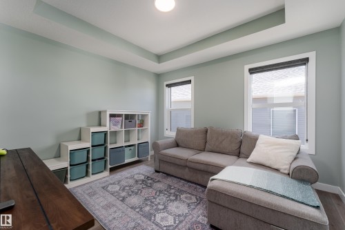 Recessed ceiling detail with a single flush-mount light fixture - 1450 Darby Green, Edmonton, AB - Indoor Photo Showing Living Room