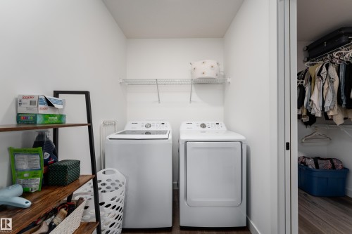 Dedicated laundry area featuring a white top-load washing machine and white front-load dryer - 1450 Darby Green, Edmonton, AB - Indoor Photo Showing Laundry Room