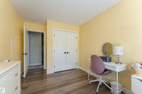 Room with wood-finish flooring, light yellow walls, and white trim - 1450 Darby Green, Edmonton, AB - Indoor
