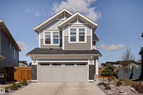 Contemporary two-story residence featuring a gray and white exterior with diverse siding textures - 1450 Darby Green, Edmonton, AB - Outdoor