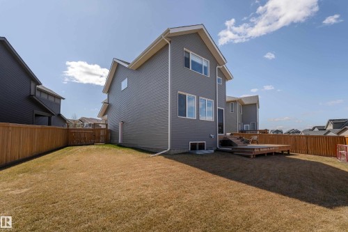 Rear exterior featuring gray horizontal siding and white trim - 1450 Darby Green, Edmonton, AB - Outdoor With Exterior
