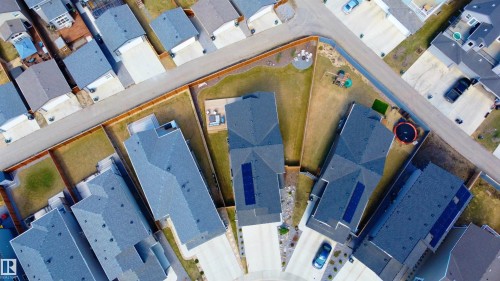 Residential neighborhood featuring modern homes with dark shingle roofs - 1450 Darby Green, Edmonton, AB - Indoor Photo Showing Other Room
