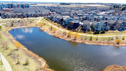 Residential properties bordering a natural water body with established pathways and mature plantings - 1450 Darby Green, Edmonton, AB - Outdoor With Body Of Water With View