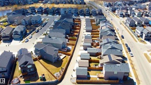 Aerial perspective of a residential community with asphalt streets and sidewalks - 1450 Darby Green, Edmonton, AB - Outdoor With View