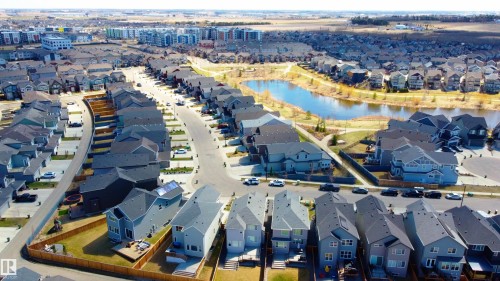 Residential neighborhood featuring a curvilinear street layout and a central pond - 1450 Darby Green, Edmonton, AB - Outdoor With View
